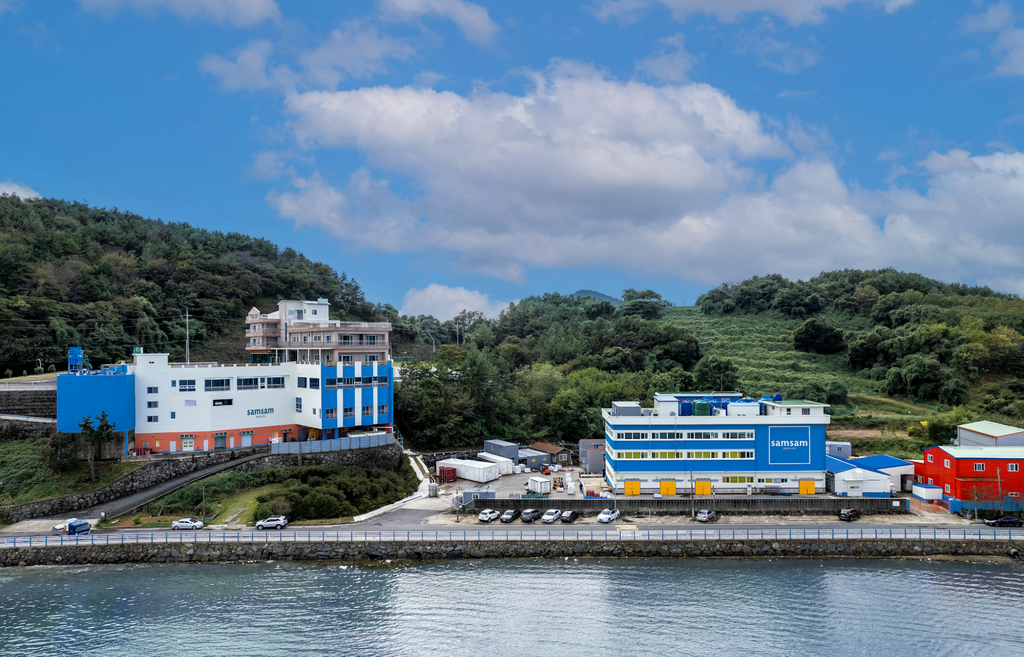 Aerial view of Samsam Mulsan's seafood processing factory buildings along the coast of Tongyeong, South Korea.